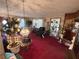A large living room with eclectic furnishings and bright red carpeting at 18401 Hamilton Rd, Dade City, FL 33523