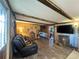 Inviting living room featuring wood accents, a comfortable sofa, and a large TV for relaxation and entertainment at 18401 Hamilton Rd, Dade City, FL 33523