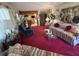 Cozy living room featuring red carpet and eclectic furnishings at 18401 Hamilton Rd, Dade City, FL 33523
