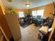 This well-lit home office offers a productive workspace with ample room for multiple desks and equipment at 18401 Hamilton Rd, Dade City, FL 33523