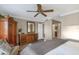 Well-lit bedroom showcasing a ceiling fan, dresser, water view from the window, and a neutral palette at 210 Dolphin Pt # B, Clearwater Beach, FL 33767