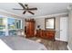 Bedroom featuring wood floors, a ceiling fan, and a water view out of the window at 210 Dolphin Pt # B, Clearwater Beach, FL 33767