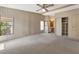 Spacious main bedroom featuring carpet floors, a ceiling fan, a closet, and an ensuite bathroom at 228 N Saint George Cir, Apollo Beach, FL 33572