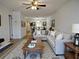 Open-concept living room featuring a comfortable sectional sofa, ceiling fan and views into the dining room at 2297 Lark E Cir # E, Palm Harbor, FL 34684