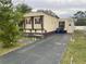 A single-story home with a paved driveway and tidy landscaping at 256 S Port Royal Ln, Apollo Beach, FL 33572