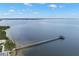 Scenic aerial view featuring a long pier extending into the serene waters of the bay with clear skies above at 280 Dr Ml King Jr N St, Safety Harbor, FL 34695