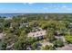 Aerial view of the neighborhood and townhome complex surrounded by lush trees with the bay in the background at 280 Dr Ml King Jr N St, Safety Harbor, FL 34695