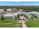 Expansive aerial shot of a resort featuring a pool, surrounded by palm trees, green lawns, and beautiful buildings at 280 Dr Ml King Jr N St, Safety Harbor, FL 34695