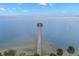 Mesmerizing aerial shot of a long pier extending into calm water, dotted with markers and framed by lush greenery at 280 Dr Ml King Jr N St, Safety Harbor, FL 34695