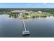 Breathtaking aerial perspective of a pier with shelter extending into bay, capturing waterfront and city's picturesque setting at 280 Dr Ml King Jr N St, Safety Harbor, FL 34695