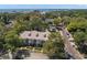 Aerial view of the townhome complex surrounded by lush trees with views of the bay in the distance at 280 Dr Ml King Jr N St, Safety Harbor, FL 34695