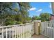 Balcony showing a view of a quiet street with lush trees and the American flag in the background at 280 Dr Ml King Jr N St, Safety Harbor, FL 34695