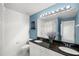 Bathroom featuring a double sink vanity with granite countertop and decorative flowers at 280 Dr Ml King Jr N St, Safety Harbor, FL 34695