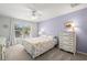 Cozy bedroom with natural light, a white iron bed frame, and a dresser at 280 Dr Ml King Jr N St, Safety Harbor, FL 34695