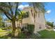 Exterior side view of a two-story home with lush landscaping and a well-manicured lawn at 280 Dr Ml King Jr N St, Safety Harbor, FL 34695