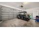 Spacious garage featuring an overhead door with windows and a golf cart for convenient transportation at 280 Dr Ml King Jr N St, Safety Harbor, FL 34695
