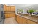 Bright kitchen featuring granite countertops, stainless steel appliances and wood cabinets at 280 Dr Ml King Jr N St, Safety Harbor, FL 34695