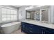 Bathroom features double sinks, soaking tub, and glass shower at 280 Dr Ml King Jr N St, Safety Harbor, FL 34695