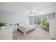 Bedroom with large window, ceiling fan, rocking chair and neutral walls at 280 Dr Ml King Jr N St, Safety Harbor, FL 34695