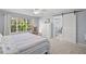 Bedroom with large window, rocker and barn door leading to bathroom with soaking tub at 280 Dr Ml King Jr N St, Safety Harbor, FL 34695