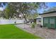Beautiful backyard with green lawn, patio area, modern lounge chairs, and a built-in grill at 2912 W Winthrop Rd, Tampa, FL 33611