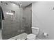 Bathroom with tiled shower and glass door with shower niche, and a toilet at 2912 W Winthrop Rd, Tampa, FL 33611