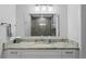 Bathroom featuring a light countertop, and mirror with three light fixtures above at 2912 W Winthrop Rd, Tampa, FL 33611