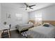 A shared bedroom featuring two twin beds, a desk, and modern decor at 2912 W Winthrop Rd, Tampa, FL 33611