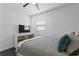 A cozy bedroom is shown with a dresser, TV, and comfortable bedding at 2912 W Winthrop Rd, Tampa, FL 33611