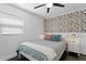 This bedroom features a stylish accent wall, ceiling fan, and coordinated decor at 2912 W Winthrop Rd, Tampa, FL 33611
