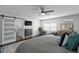 Primary bedroom featuring a barn door to the bathroom, dresser, TV, and ceiling fan at 2912 W Winthrop Rd, Tampa, FL 33611
