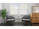Bright seating area featuring two armchairs with side table, a light fixture and a window at 2912 W Winthrop Rd, Tampa, FL 33611