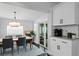 Inviting dining room with a stylish chandelier, modern table set, and access to the outdoor patio at 2912 W Winthrop Rd, Tampa, FL 33611