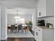 Elegant dining area with a modern table set, stylish chandelier, and convenient access to the kitchen at 2912 W Winthrop Rd, Tampa, FL 33611