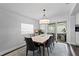 Bright dining room with modern furnishings, a stylish chandelier, and a sliding door to the backyard at 2912 W Winthrop Rd, Tampa, FL 33611