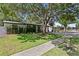 Charming single-story home with lush landscaping and a welcoming front entrance and covered parking at 2912 W Winthrop Rd, Tampa, FL 33611