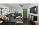 Cozy living room featuring dark wood floors, recessed lighting, fan and large sectional couch at 2912 W Winthrop Rd, Tampa, FL 33611