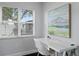 Bright home office with large window and a white desk with neutral accents at 2912 W Winthrop Rd, Tampa, FL 33611