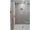 Shower with a handheld shower head, clear glass doors, and tiled shower niche at 2912 W Winthrop Rd, Tampa, FL 33611