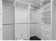 Walk-in closet featuring shelves, drawers, dark wood floors, and hanging storage at 2912 W Winthrop Rd, Tampa, FL 33611