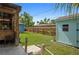 A lush backyard showcasing a well-maintained lawn, wooden fence, and charming sheds, ideal for outdoor enjoyment at 2915 67Th Way N, St Petersburg, FL 33710