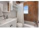 Well-lit bathroom featuring a modern vanity, tiled walls, and shower/tub combination, offering a serene retreat at 2915 67Th Way N, St Petersburg, FL 33710