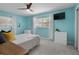 Well-lit bedroom with a ceiling fan, television, and carpet, offering a comfortable space at 2915 67Th Way N, St Petersburg, FL 33710