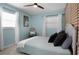Inviting bedroom featuring a chair, two windows, and a comfortable bed with stylish pillows at 2915 67Th Way N, St Petersburg, FL 33710