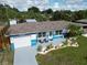 Well maintained single-story home with a cozy front porch, manicured lawn, and attached garage at 2915 67Th Way N, St Petersburg, FL 33710