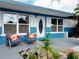 Close up of front porch featuring comfortable seating and beautiful landscaping at 2915 67Th Way N, St Petersburg, FL 33710