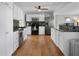 Updated kitchen with white cabinets, stainless steel appliances, dark countertops, and hardwood floors at 2915 67Th Way N, St Petersburg, FL 33710