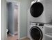Updated laundry room with stacked washer and dryer and adjacent bathroom with tiled shower at 2915 67Th Way N, St Petersburg, FL 33710