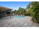 Private backyard pool with a covered bar area, lush landscaping, and comfortable lounge seating at 2915 67Th Way N, St Petersburg, FL 33710