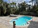 Beautiful backyard pool with lounge chairs surrounded by tropical landscaping at 2915 67Th Way N, St Petersburg, FL 33710